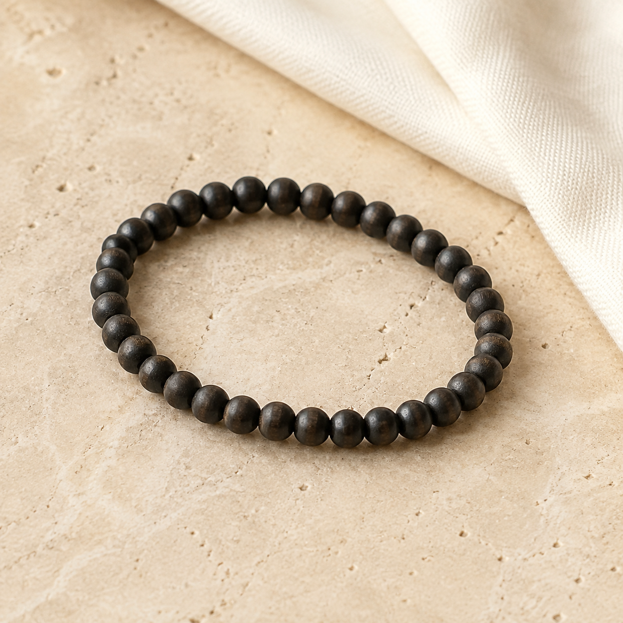 Plain Karungali bracelet on warm natural stone