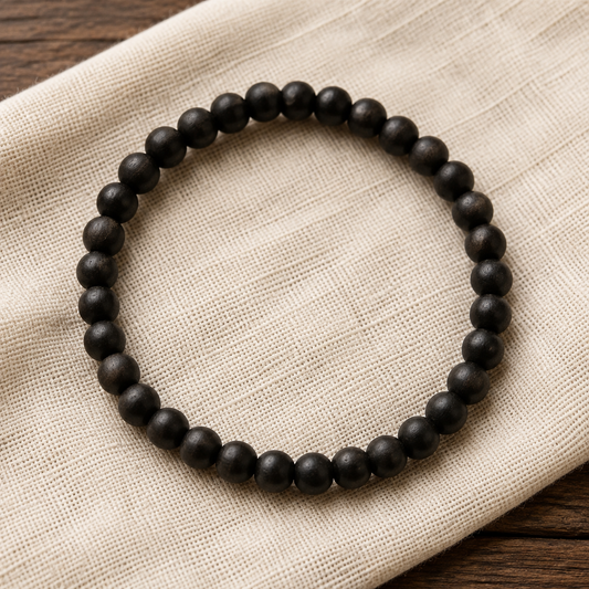 Plain Bhakthination Karungali bracelet on ivory linen
