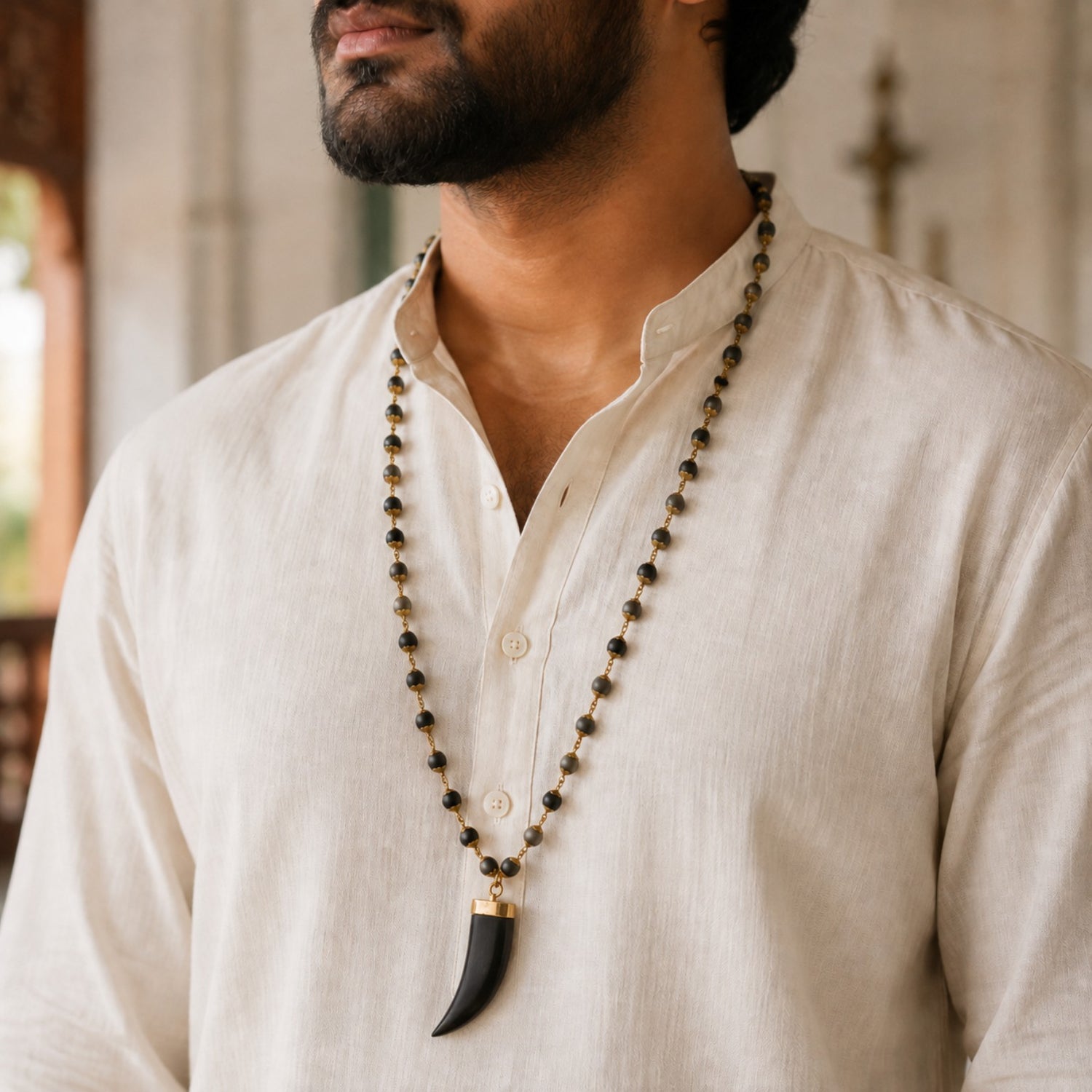 Bhakthination Karungali mala worn with an ivory kurta