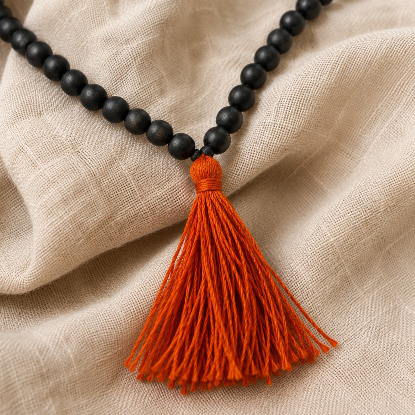 Classic Karungali Mala orange tassel detail