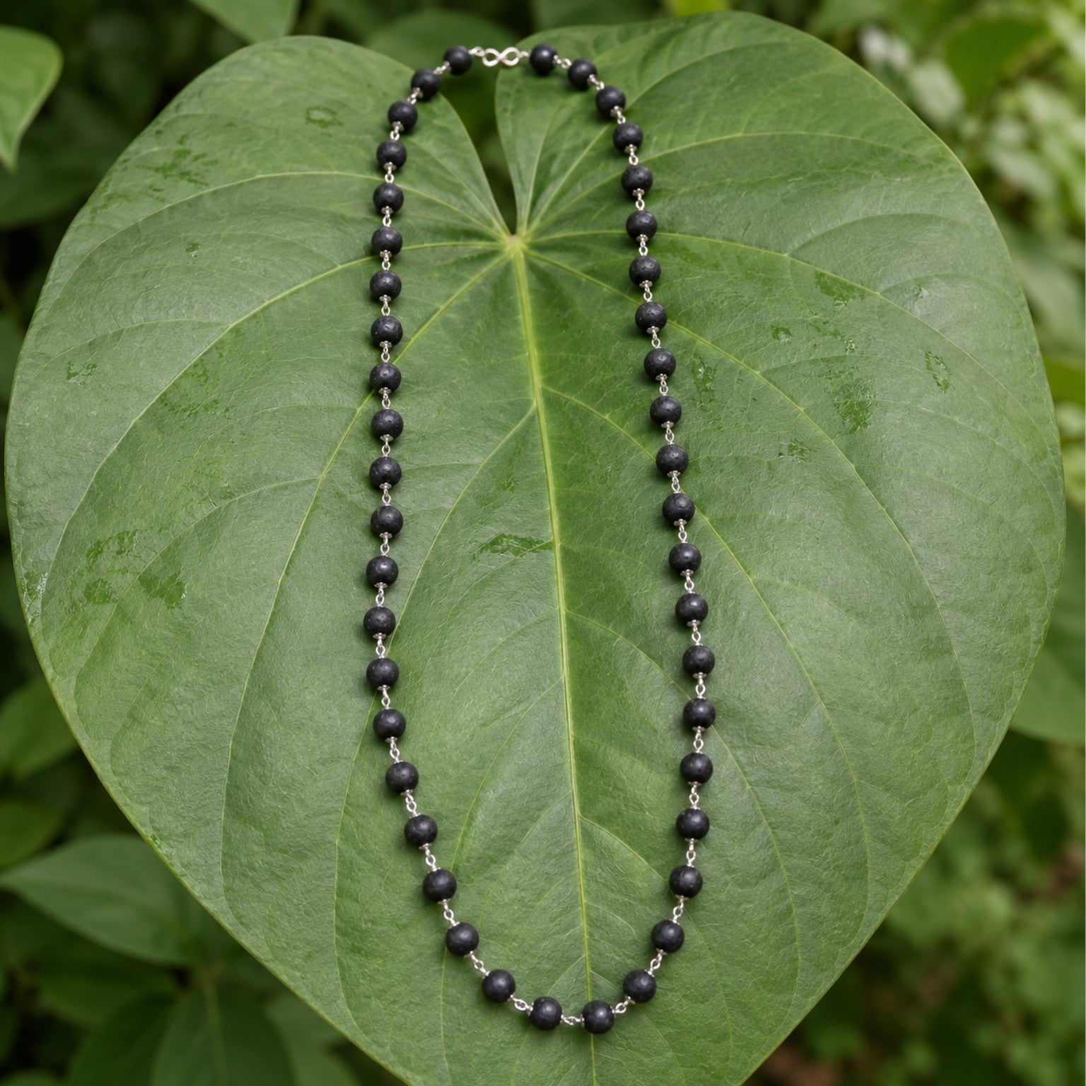 Silver-Finish Karungali Mala on a leaf