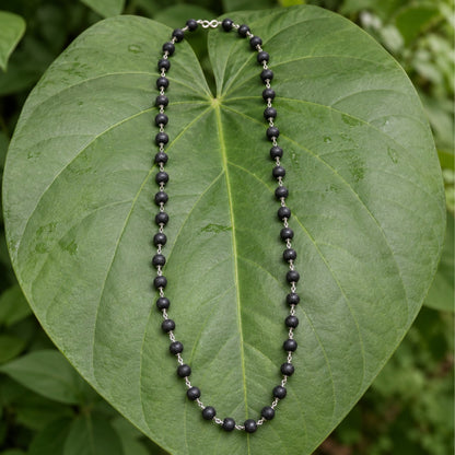 Silver-Finish Karungali Mala on a leaf