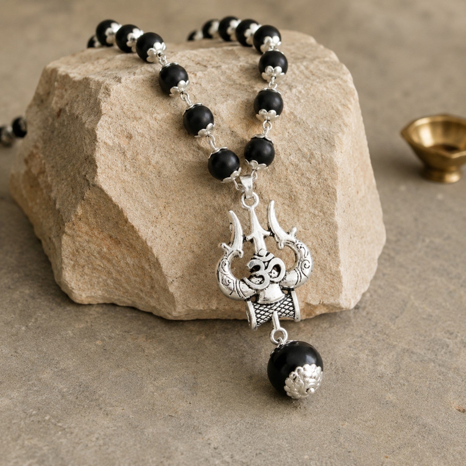 Silver Om Trishul Karungali Mala on stone