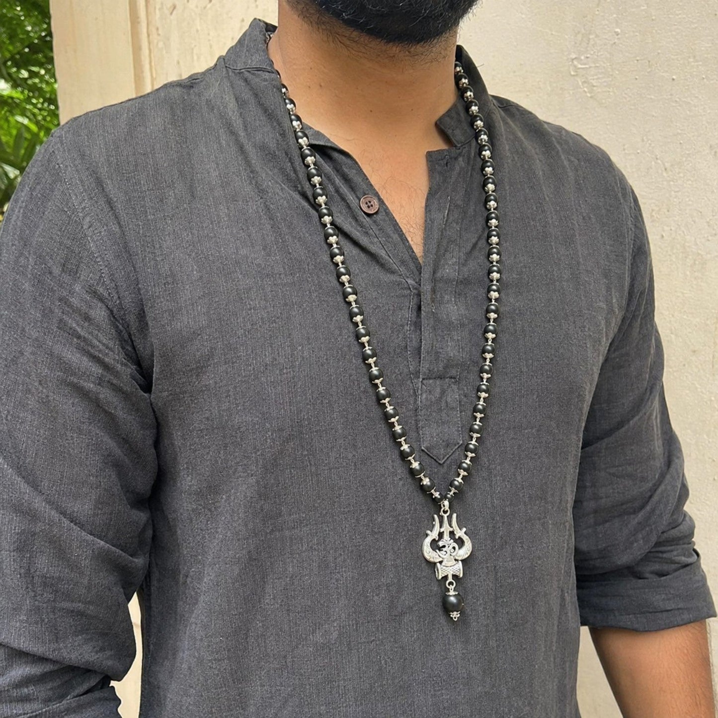 Silver Om Trishul Karungali Mala worn by a model