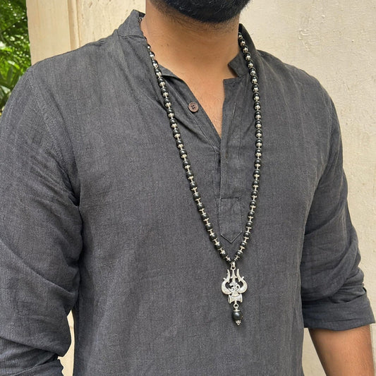 Silver Om Trishul Karungali Mala worn by a model